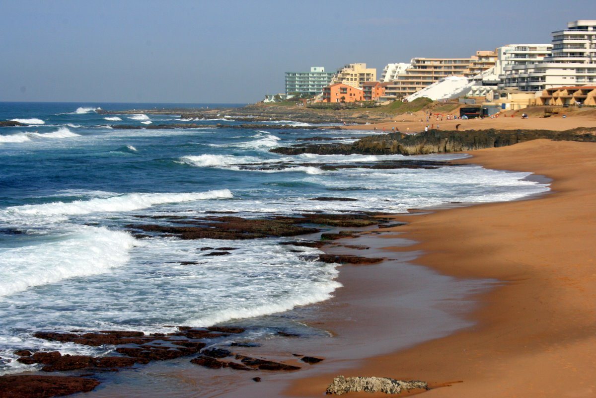 Ballito beachfront: rocky shoreline, golden sand and beachfront apartments